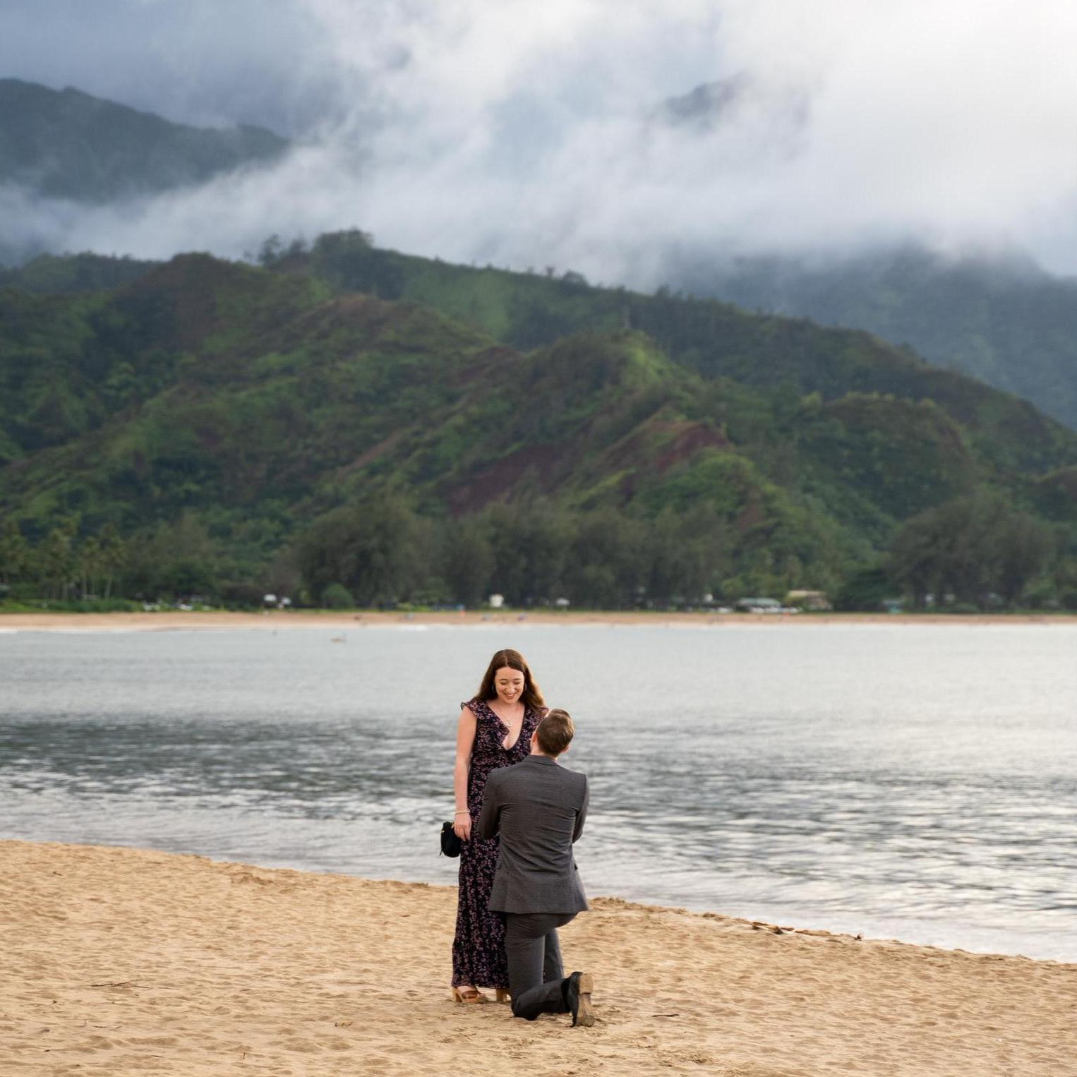 Isaac getting down on one knee & popping the question in Hanalei Bay, Hawaii.