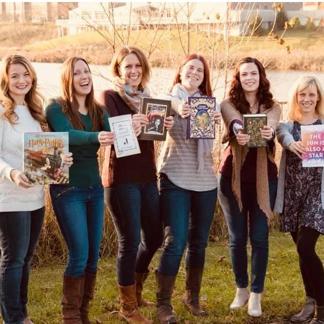 Jackie with several of her bridesmaids doing a photo shoot together and showcasing their love for reading, one of the many things that have bonded them together through the years,