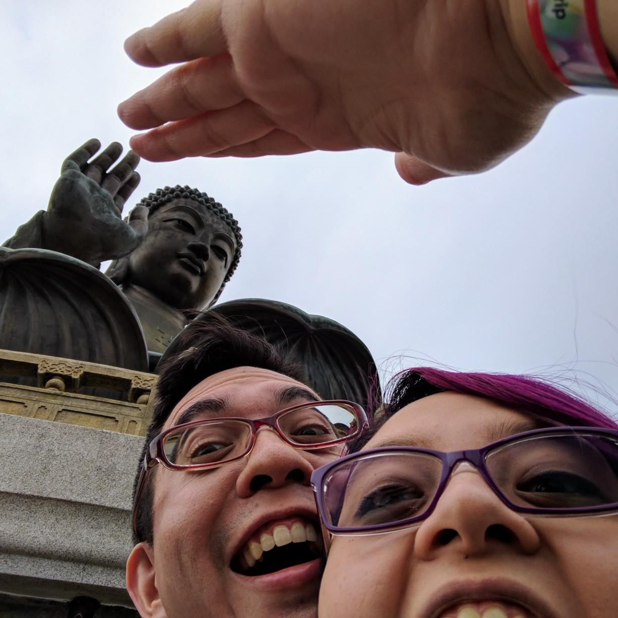 Giving Buddha a high five at Lantau, Hong Kong.