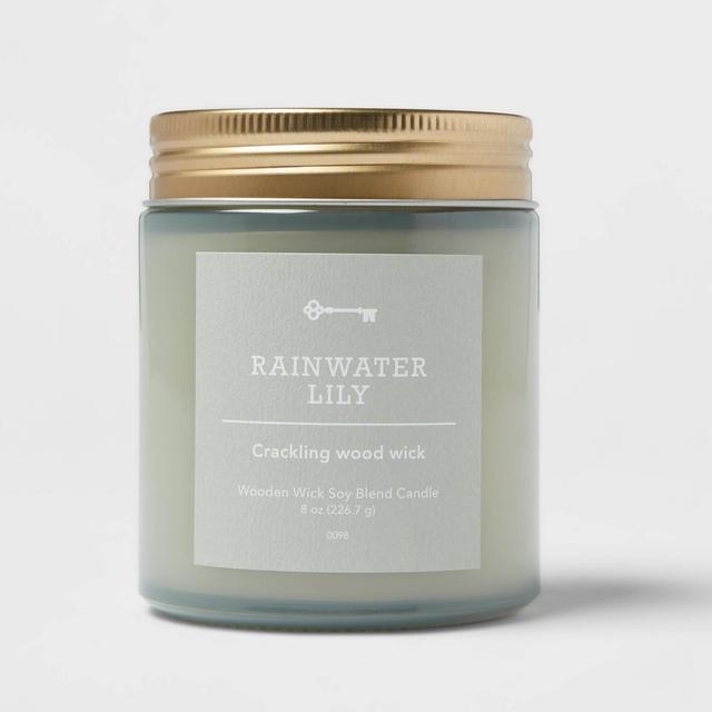 8oz Tinted Blue Glass Woodwick Candle with Gold Metal Screw Top Lid Rainwater Lily - Threshold™