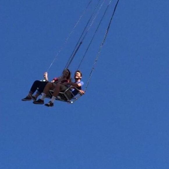 Riding the swings together at the state fair before we were dating.