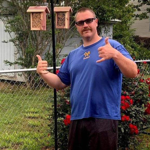 Kyle supporting Abbi's obsession with bird feeders.  And that Stache!
