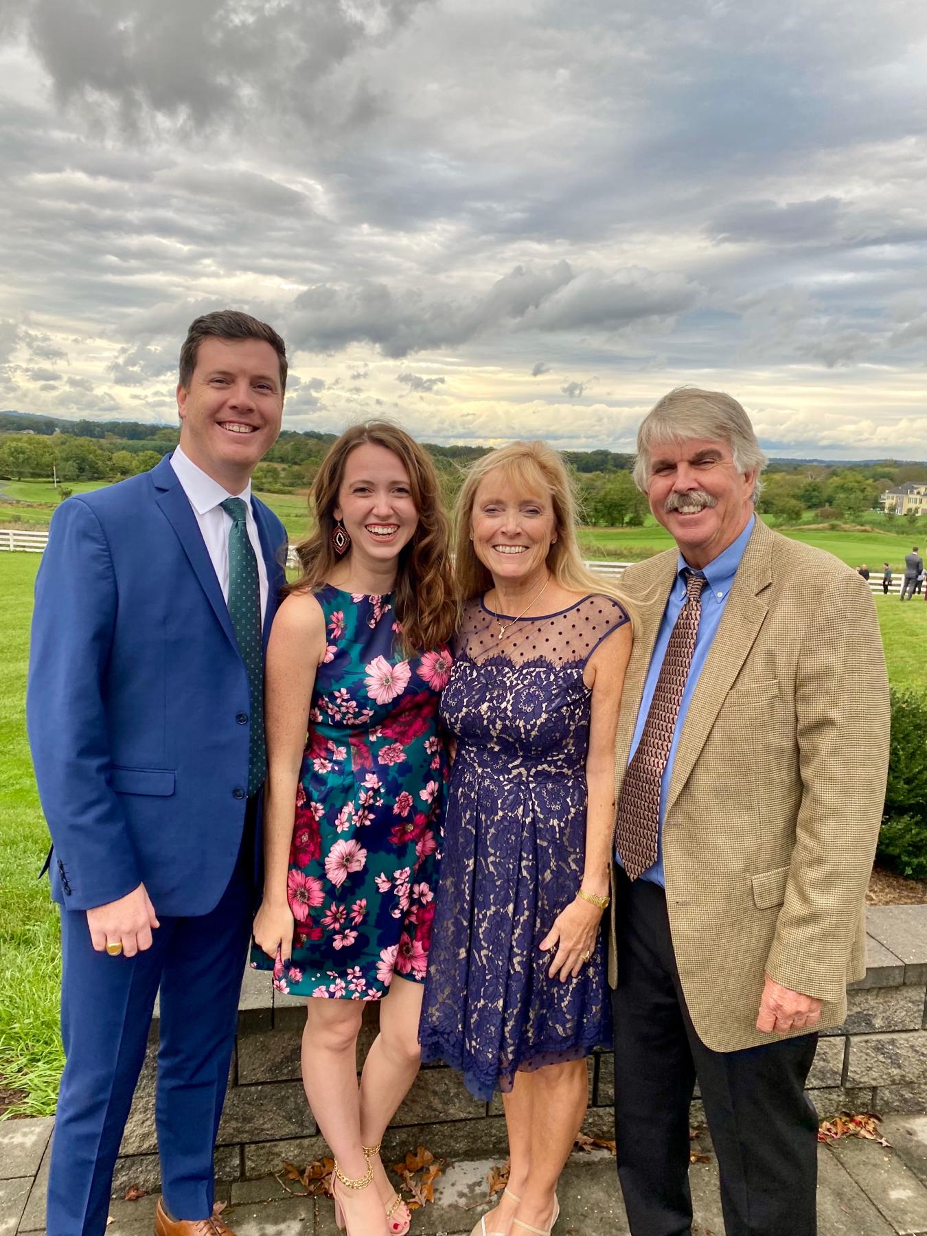 October 2021 - Smiling for a group photo with Sydney’s parents at a family friend’s wedding in Northern Virginia.