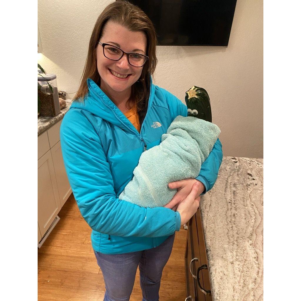 So, this is Zoe Zucchini. One time we had a client that couldn't pay us, so they gave us a GIANT zucchini. We popped some googly eyes and baby clothes on it and BAM! Zoe came into our lives.