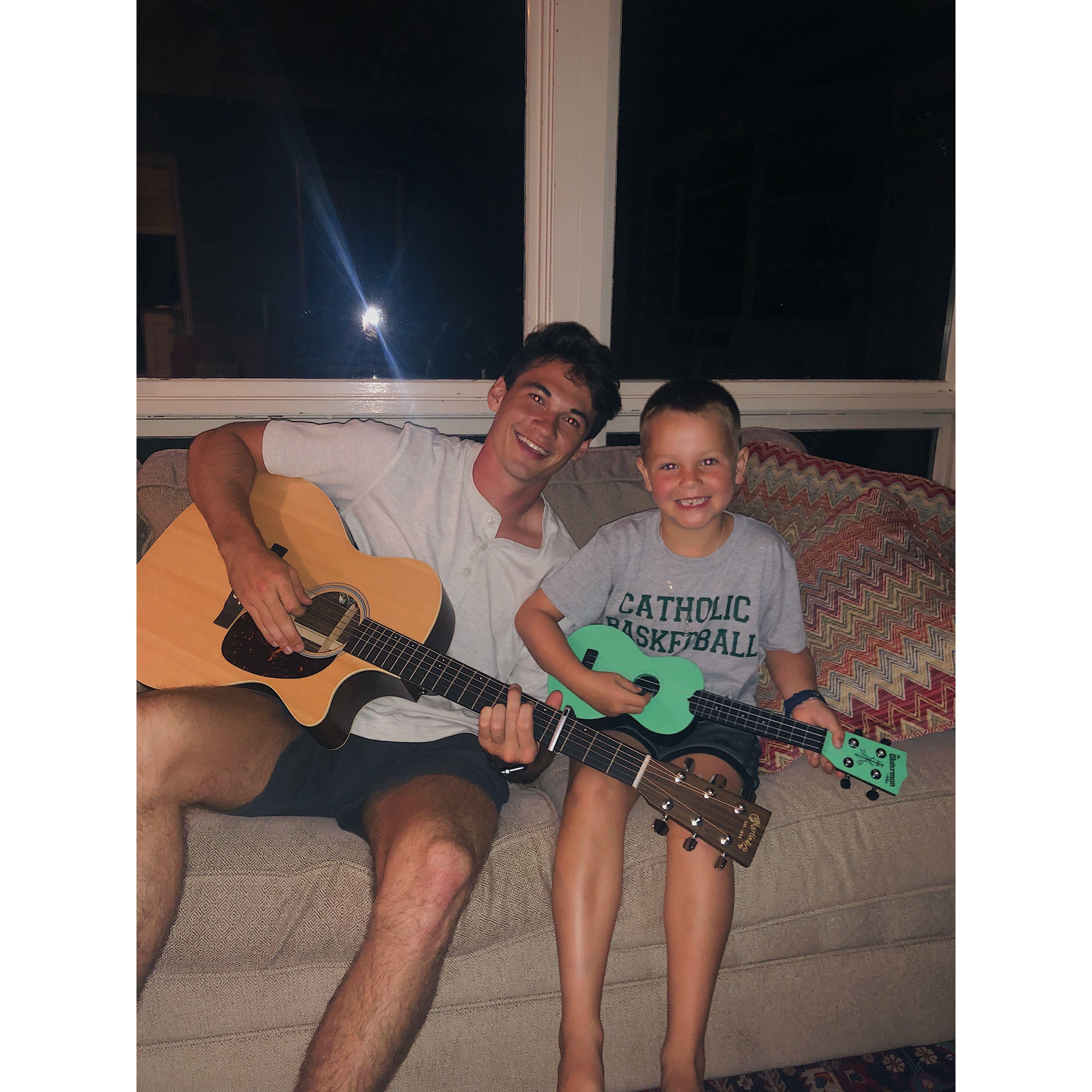 Cute picture of Jonah showing little Jack guitar (2019)
