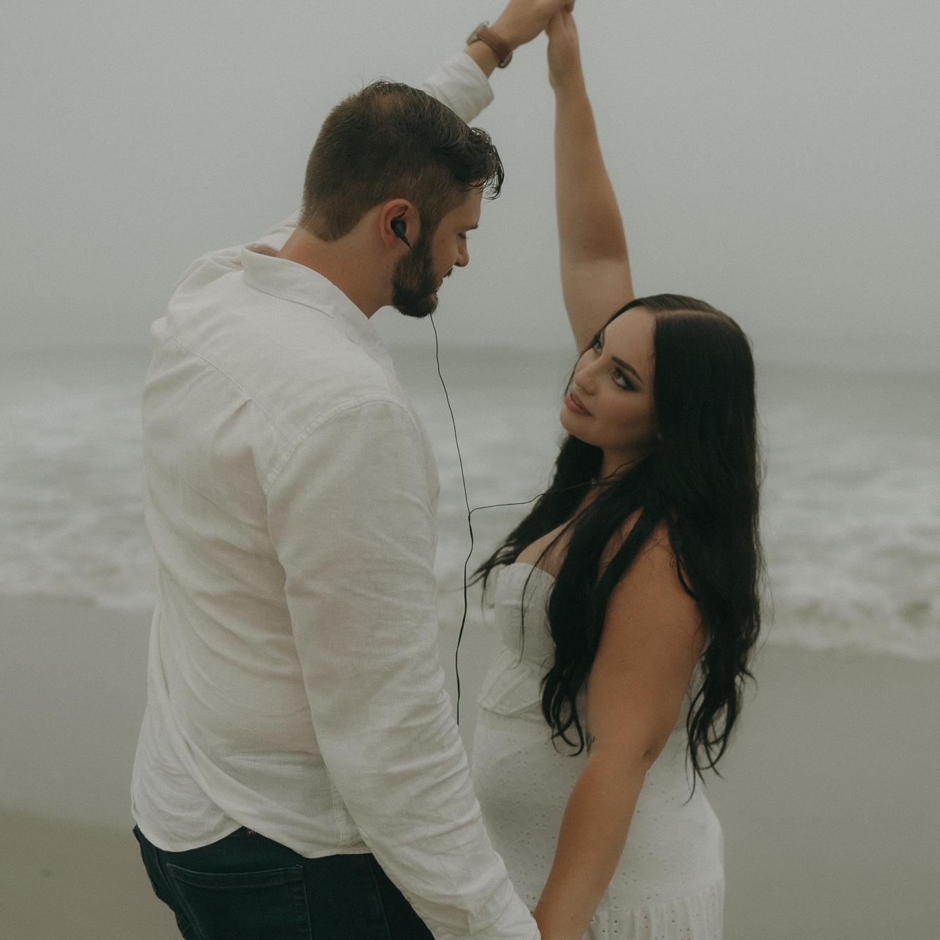 Listening to music and dancing on the beach on a misty afternoon