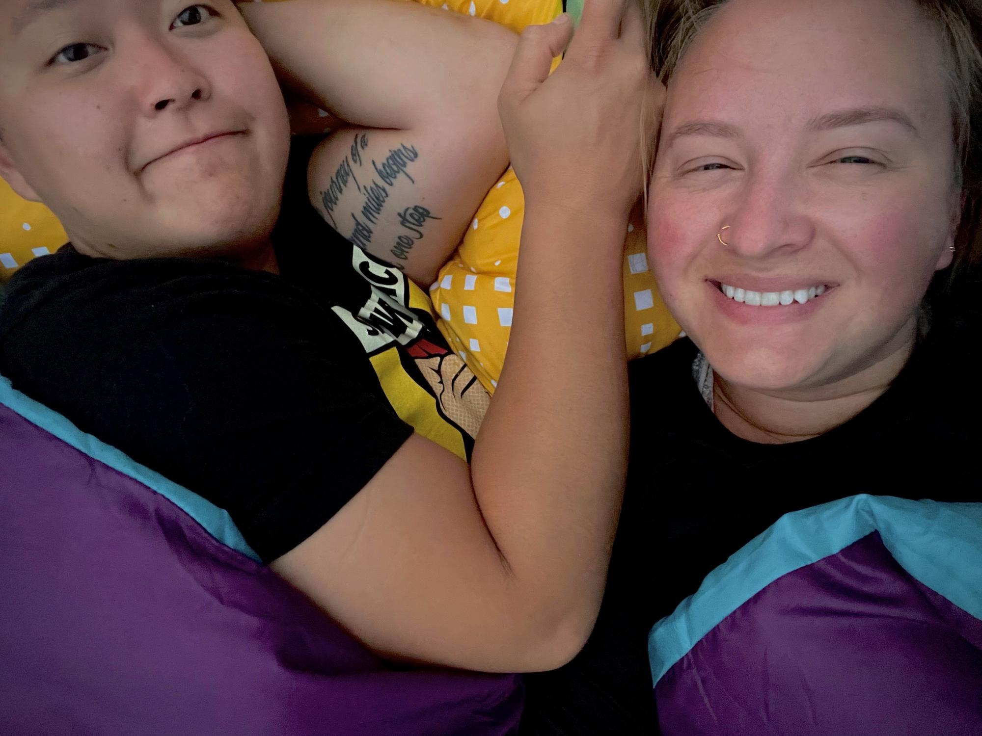 Our second camping trip together in 2021 with Kelsey (Anhthu’s Matron of Honor) and Alex! Picture description: A selfie of Anhthu & Ashley in a sleeping bag with sleepy eyes & smiles.