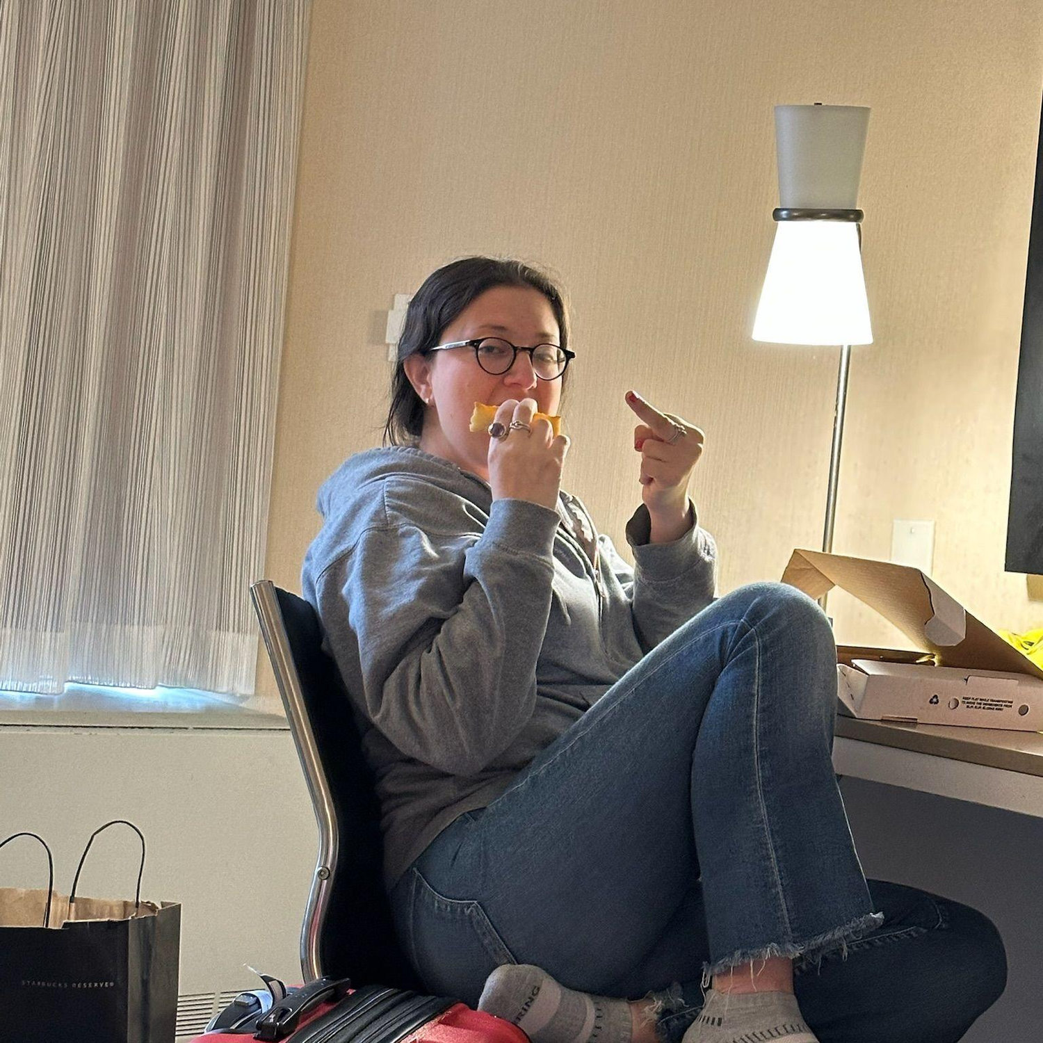L, morning after vibes—leftover Chicago pizza in hand, flipping M the bird. Classy? Never. Iconic? Always.
