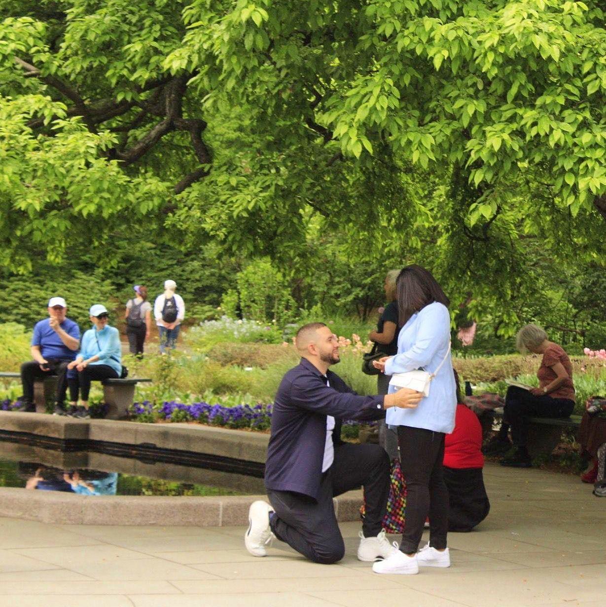 Elliott proposing in the Conservatory Garden' Burnett Fountain. A hidden gem in the city with a lot of personal significance to Elliott who grew up in the area.