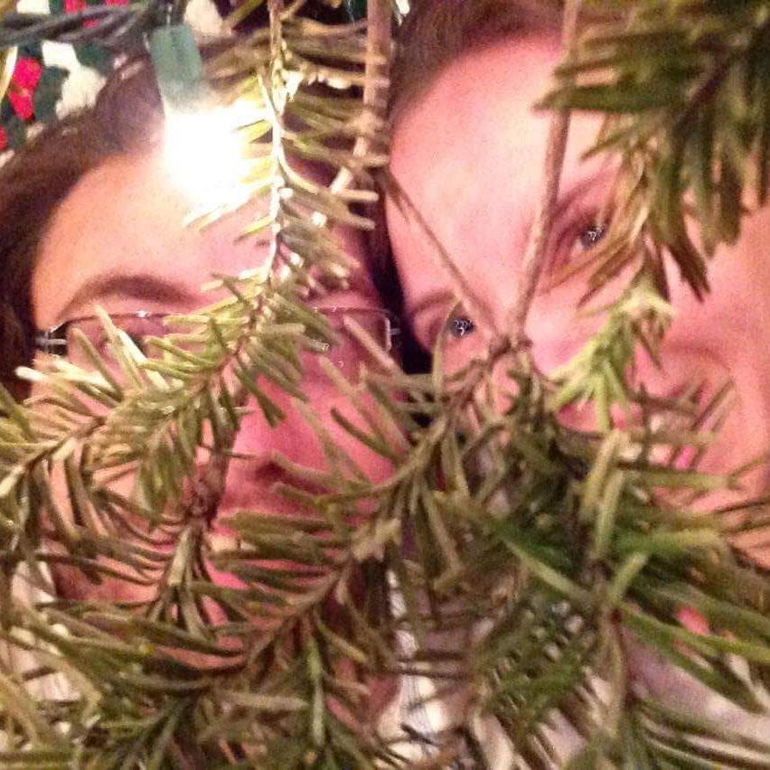 Derek joining Jessica in one of her favorite Christmas traditions, laying under the un-decorated Christmas tree.