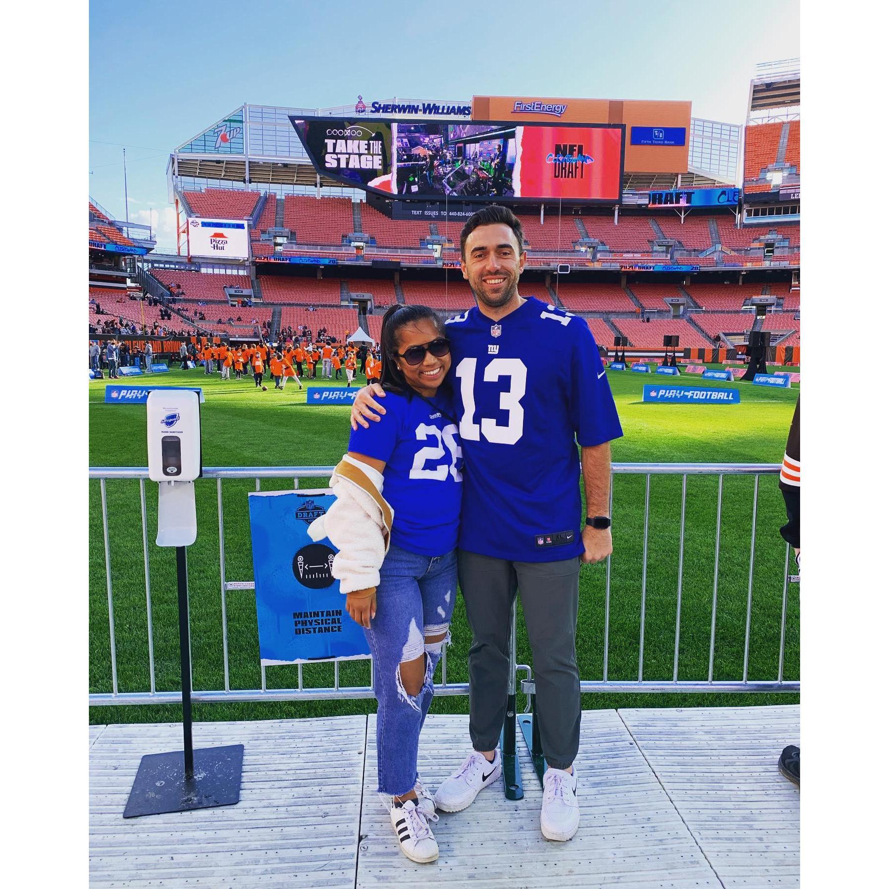 The NFL Draft in Cleveland & both wearing jerseys of NYG ex-players.