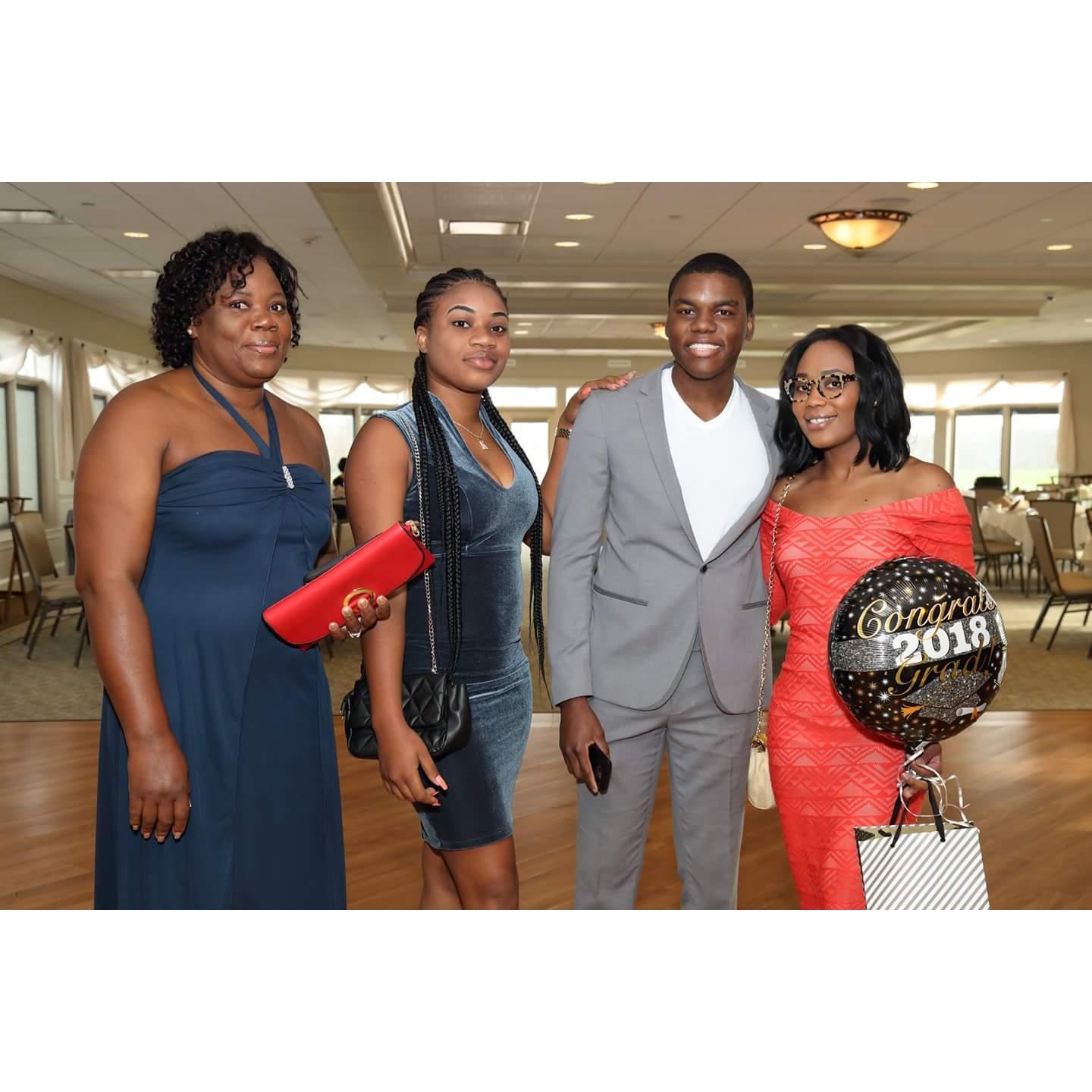 Celebrating Romaine's graduation award's dinner with his mother and sister in 2018.