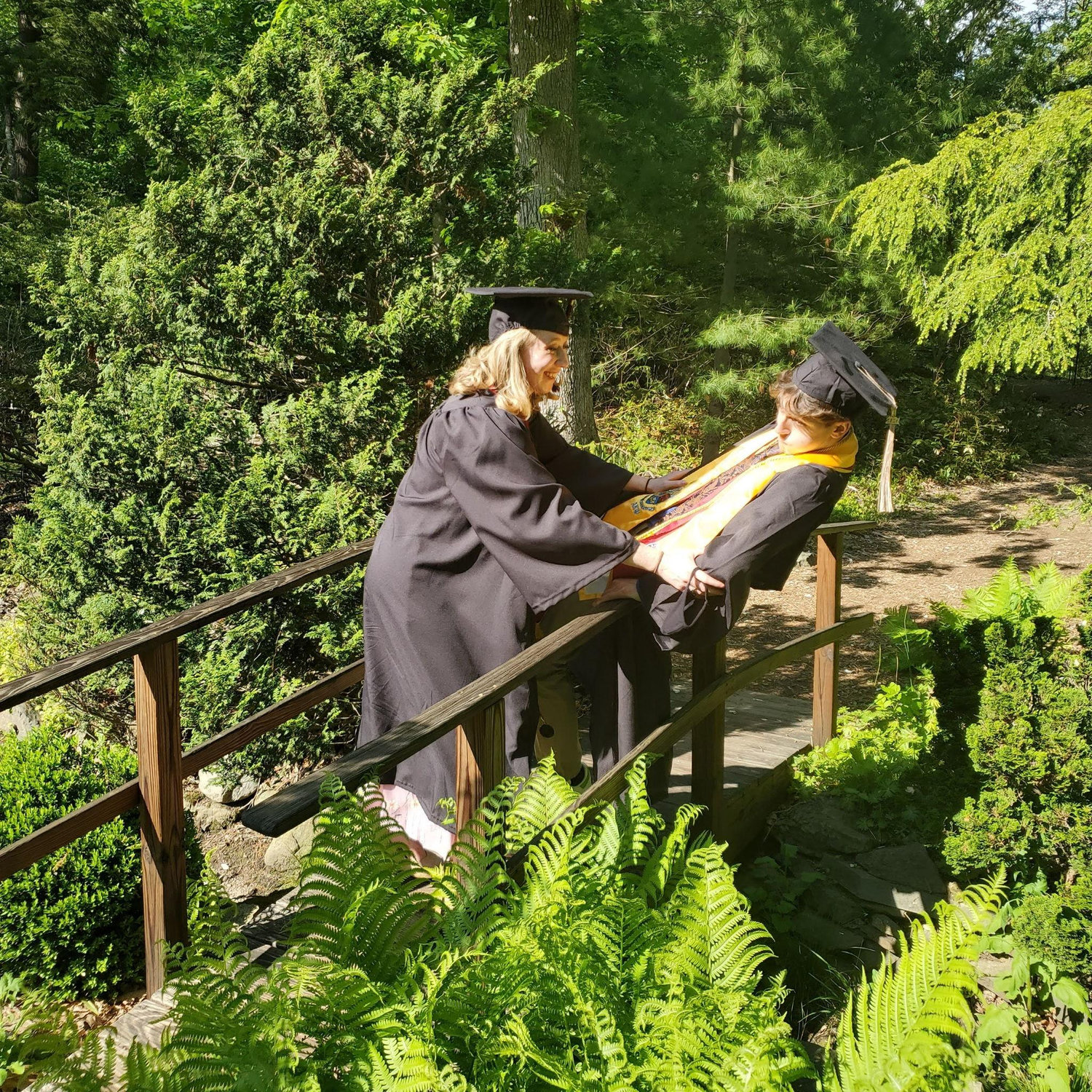 Em pushing Jack off a bridge at graduation