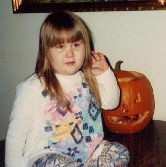 Posing with a pumpkin for Halloween in the early 90s.