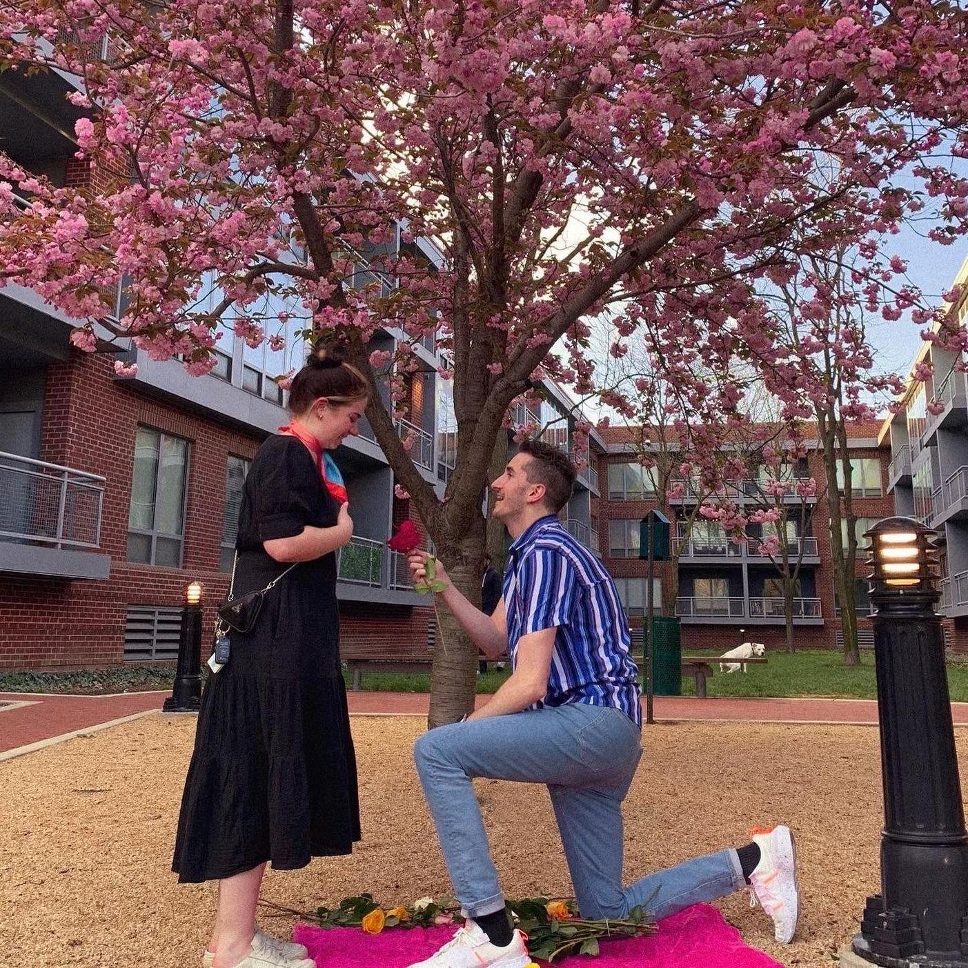 Matthew proposed outside of the apartment they shared, under a beautiful pink magnolia tree, surrounded by their closest family. And this dog. Who promptly took a shit in the background.
