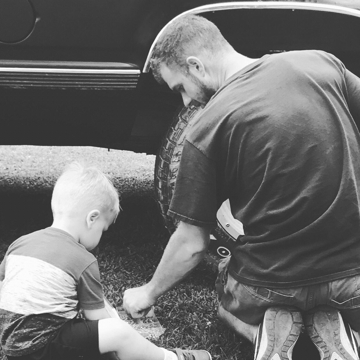 Daddy and son workin on the ole girl