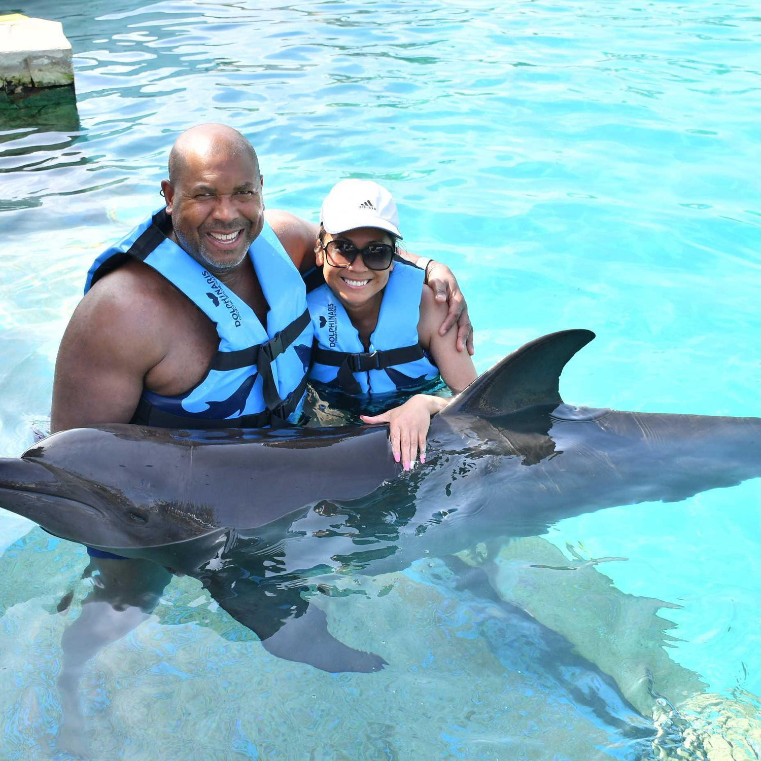 Love is when your partner steps out of his comfort zone, like when Mike joined me in the dolphin cove in Cancun.