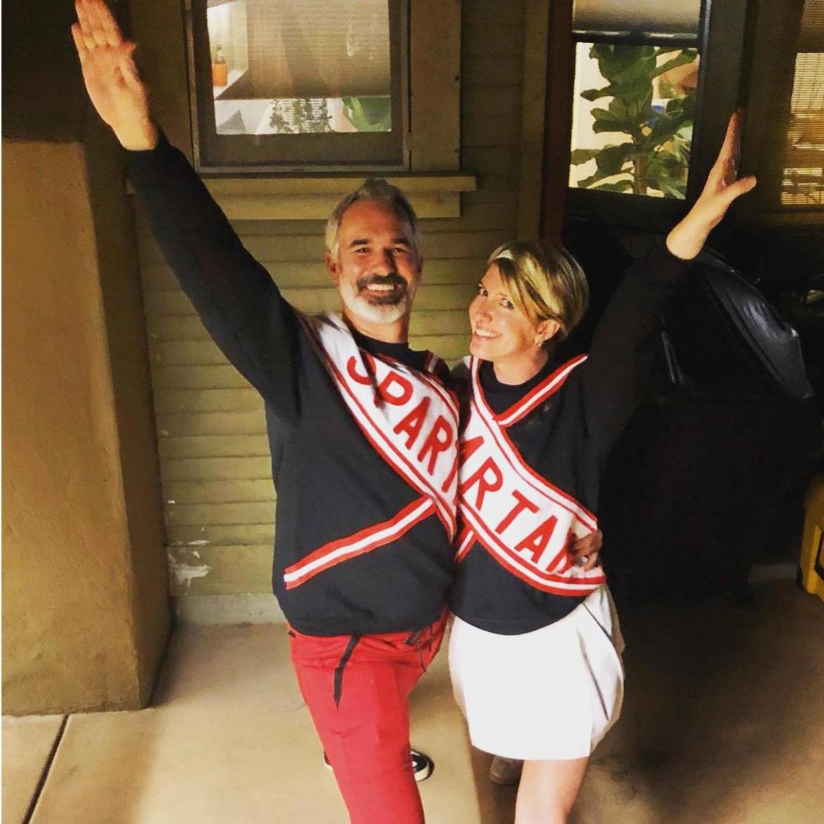 The couple that costumes and cheers together . . .
