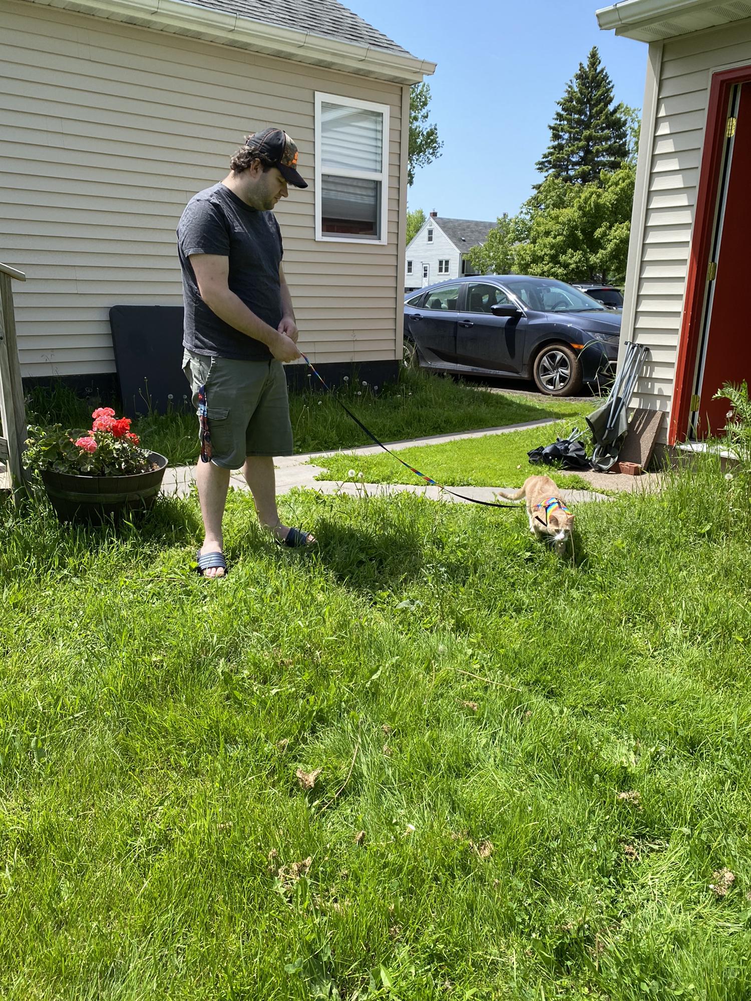 Logan taking our cat, Max, for a walk