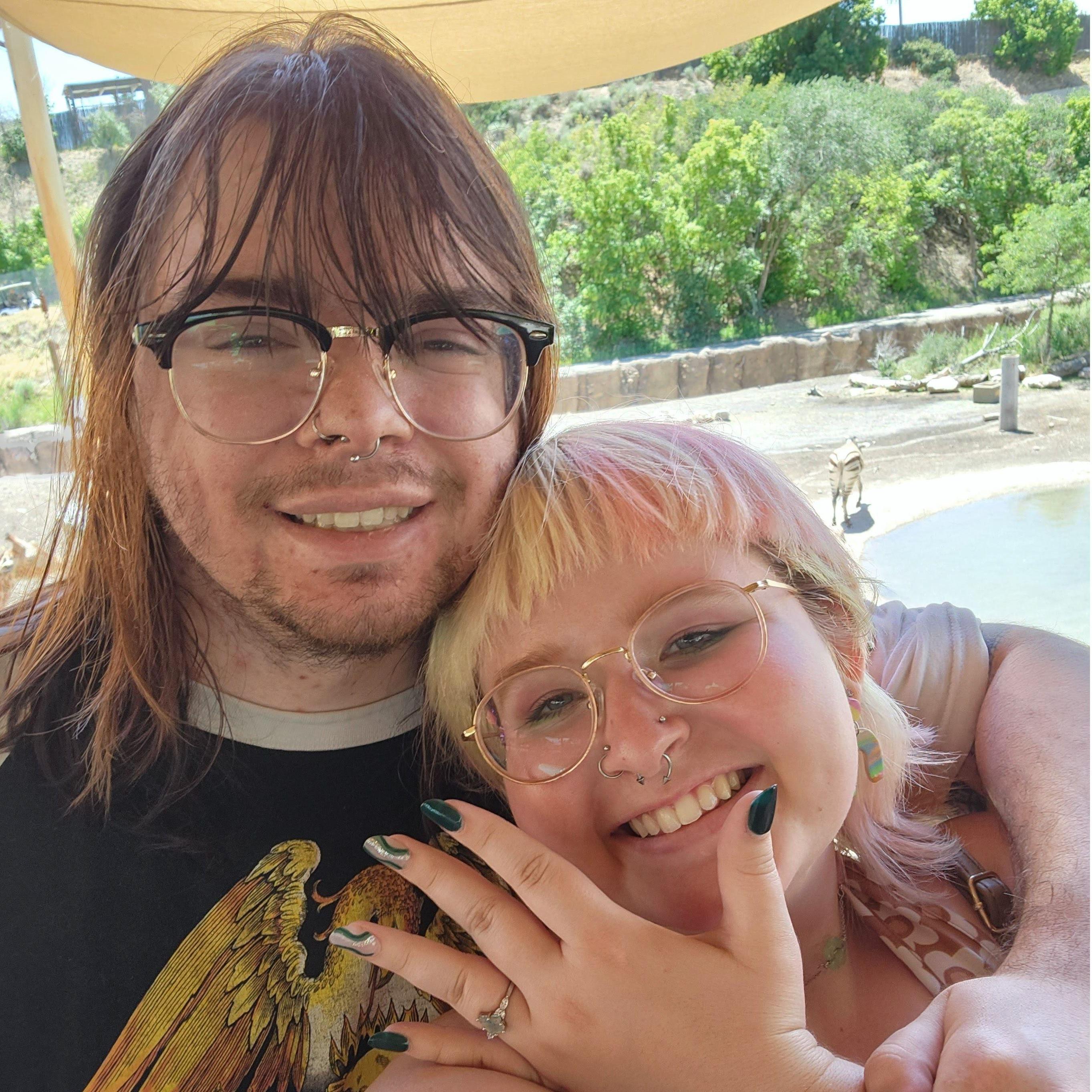 Right after we got engaged but with better lighting this time (and in front of the giraffes)