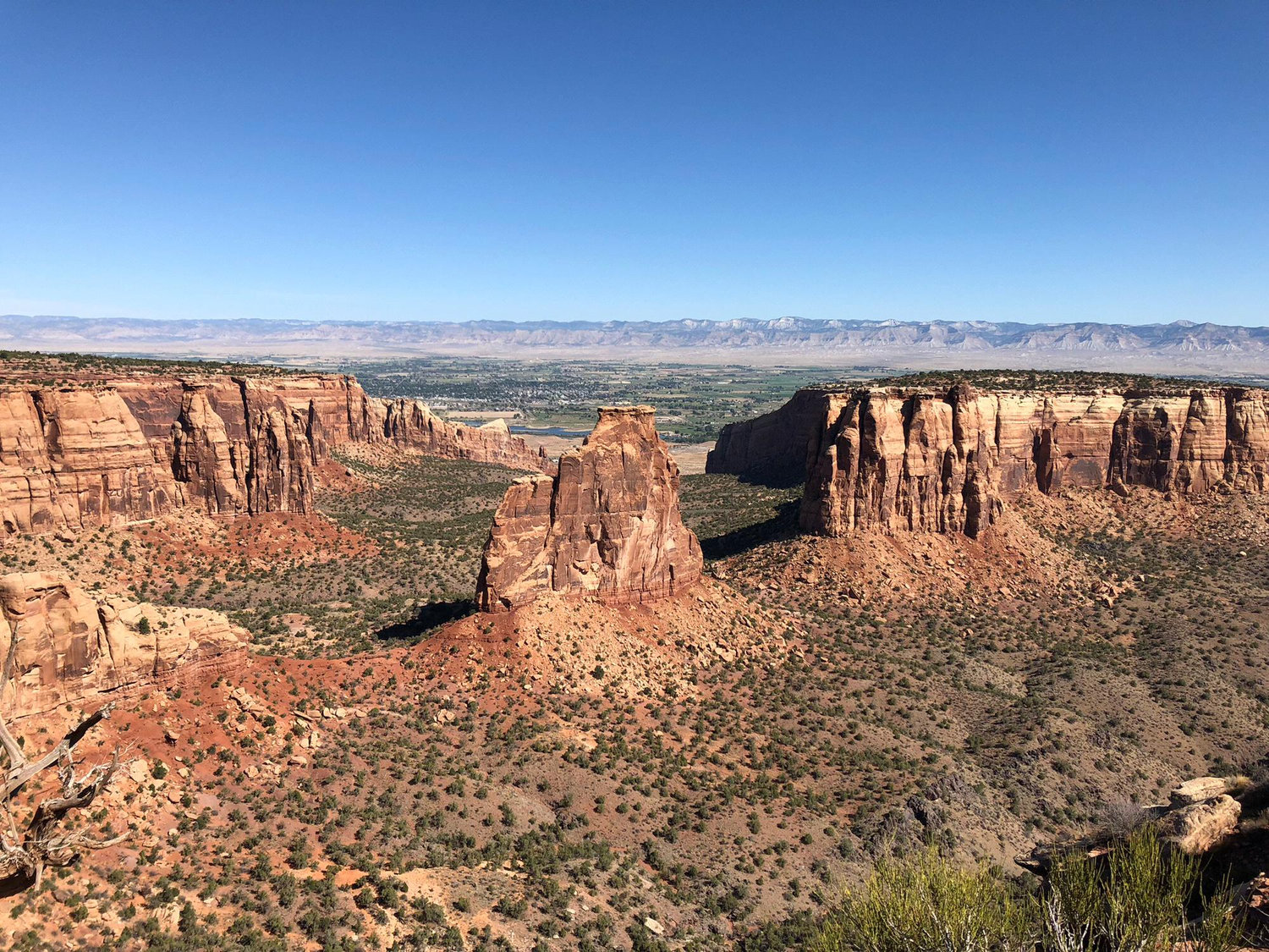 Where the proposal happened, standing on the edge of a cliff looking over Independence Monument in Colorado National Monument. Grand Junction, CO on September 15, 2018.
