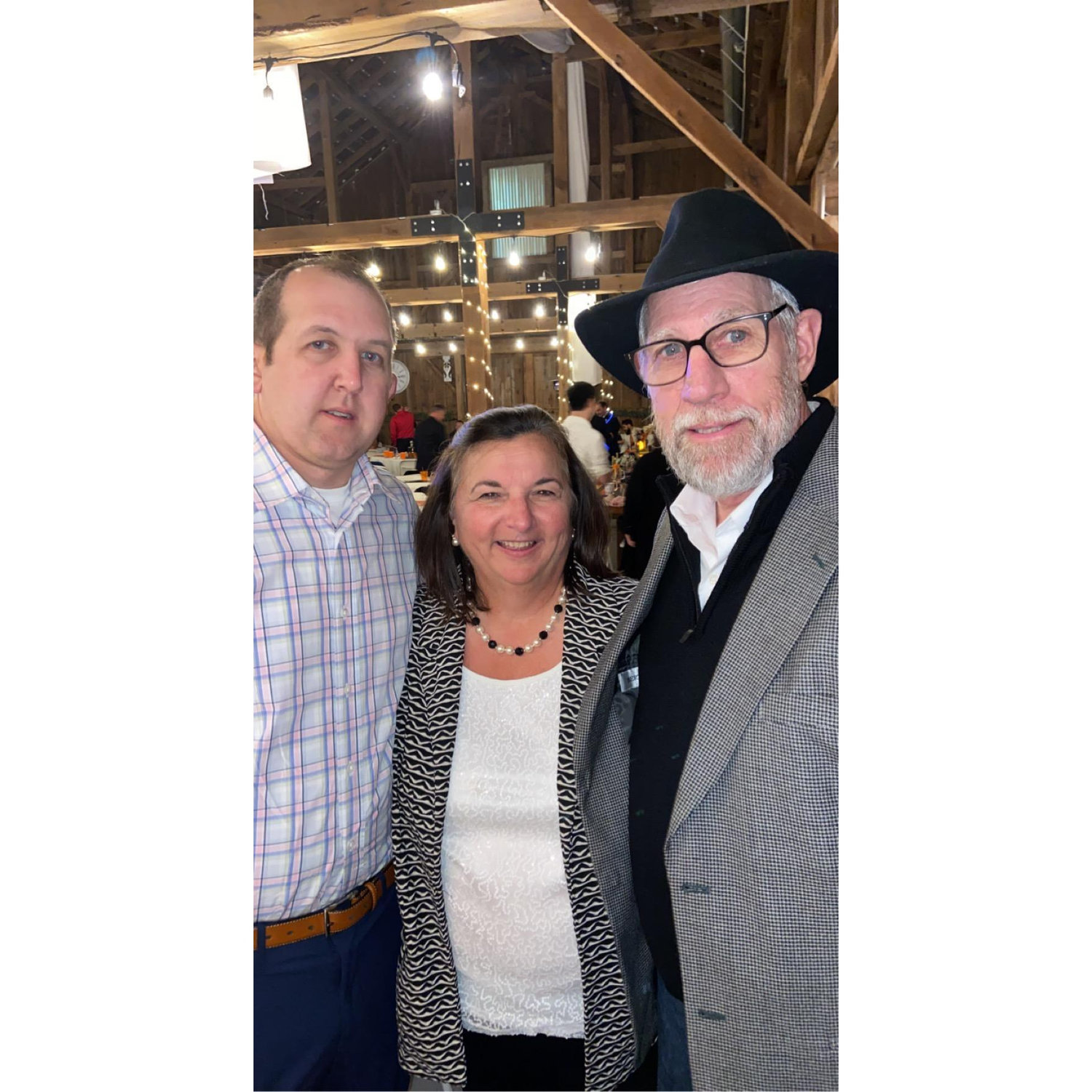 Joe with Katie’s parents at a wedding.