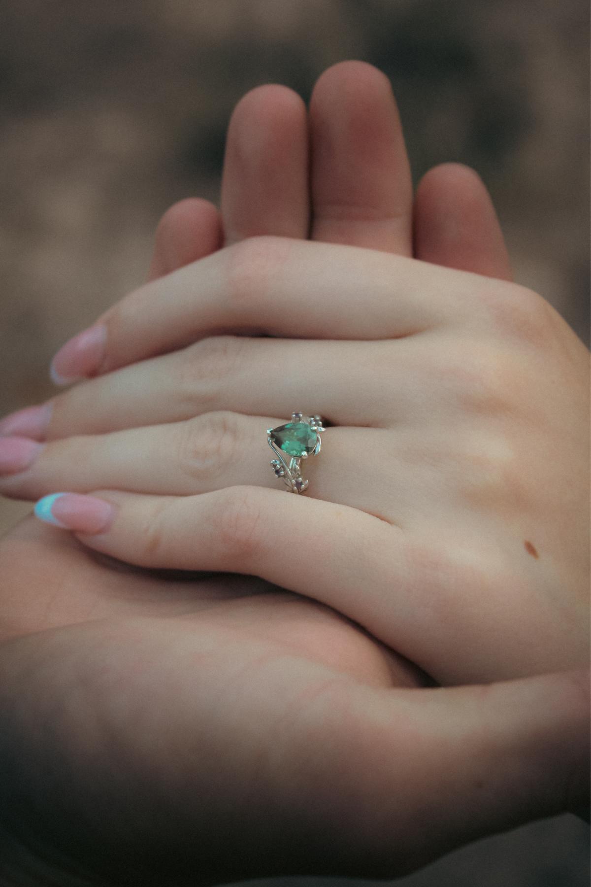 The gorgeous engagement ring :) It’s an alexandrite stone which is considered a emerald by day and a ruby by night. Chris certainly did an amazing job!