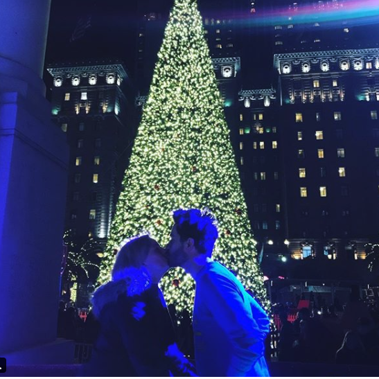 Kissing under the Christmas tree.