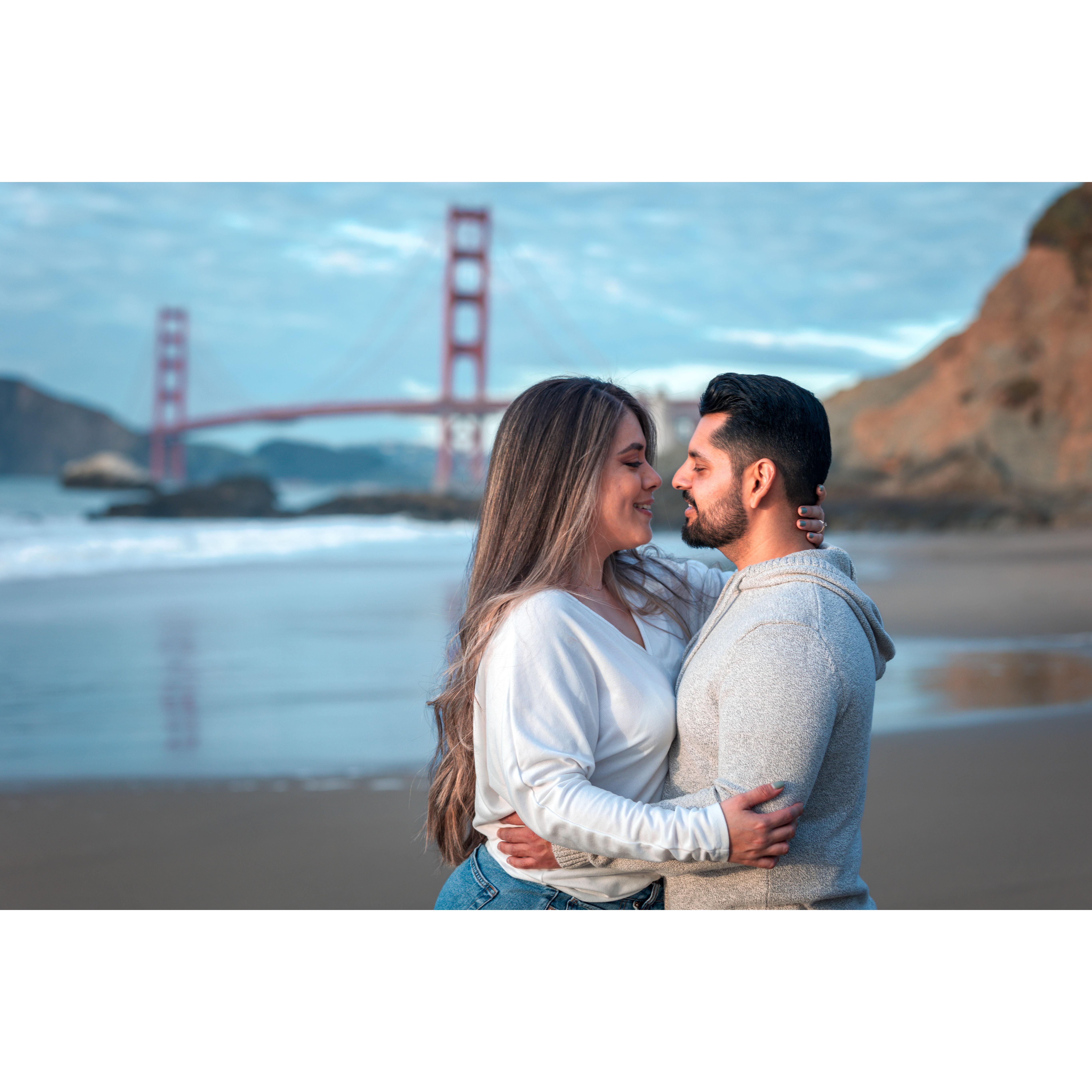 Lost in the warmth of her gaze, with the Golden Gate witnessing our sunset embrace. 🌅💑 #SunsetLove #GoldenGateHeartbeat