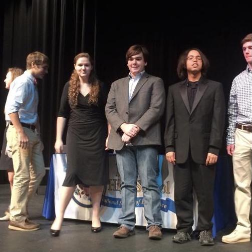 the happy couple being inducted into NHS, next to eachother and clueless of their future together