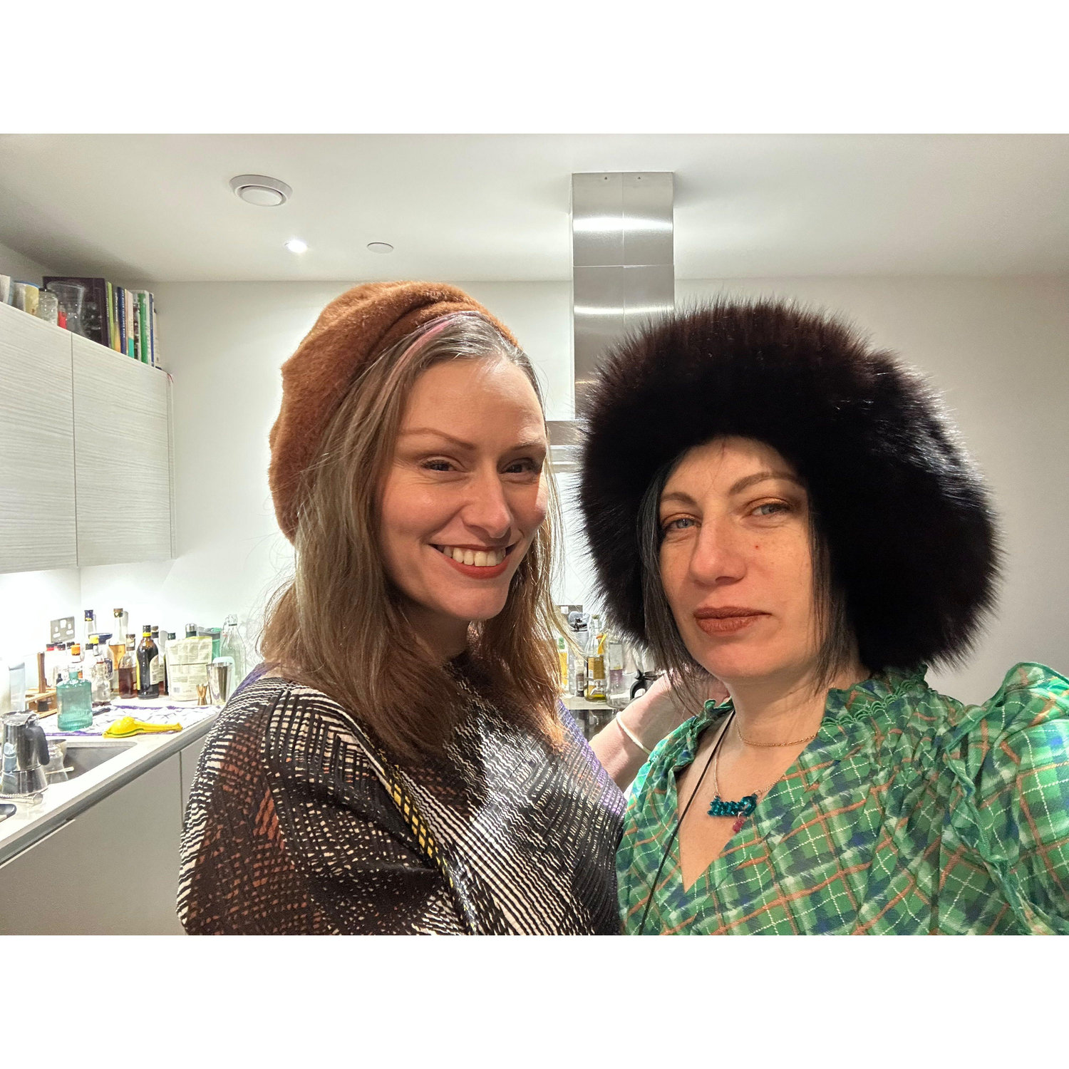 Trying on hats in Gabrielle's flat before going out to a friend's exhibition.
