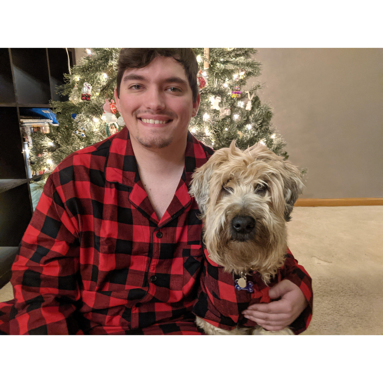 Tom and Olly in matching PJs posing for a Christmas card photo in 2020.