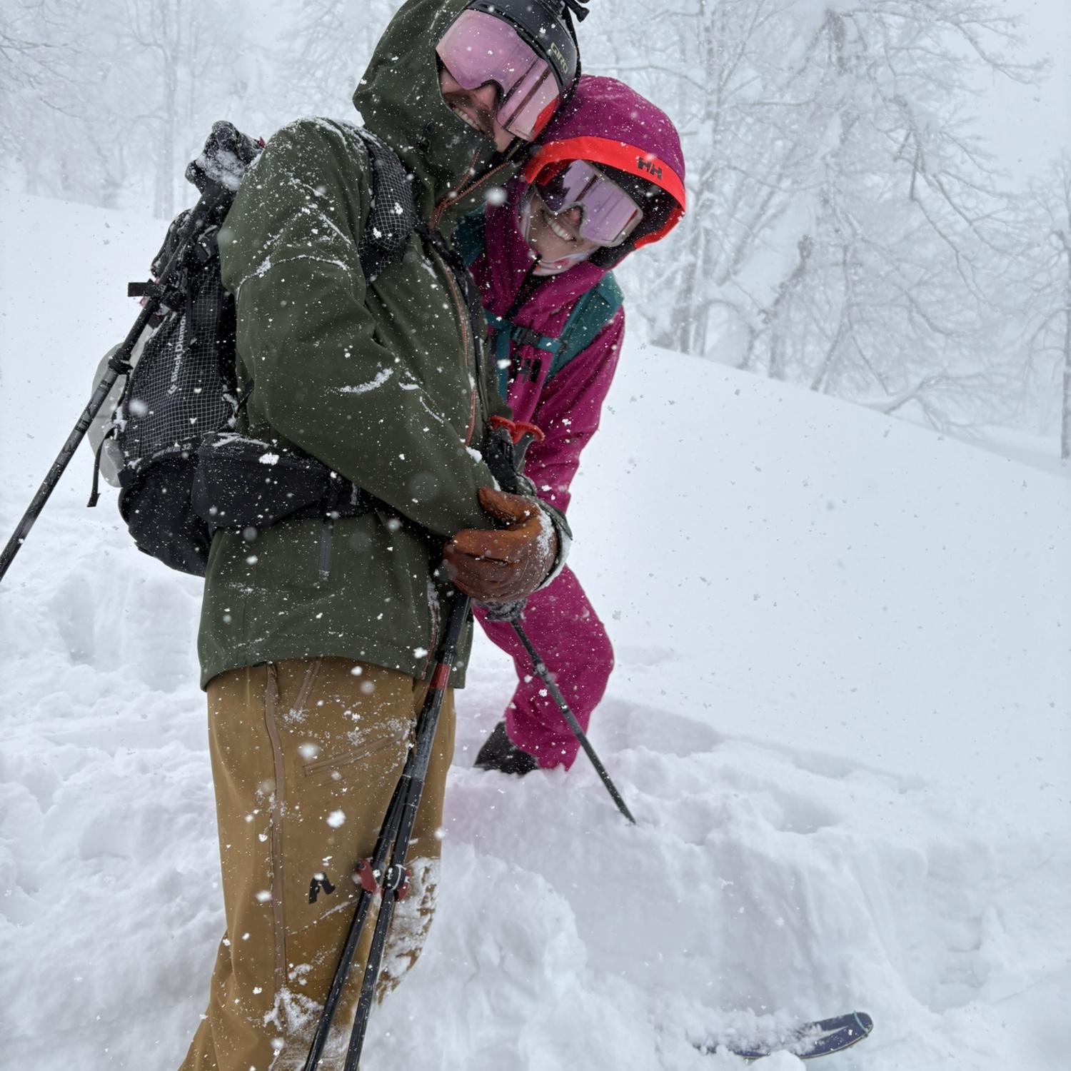 Backcountry ski buddies on an epic powder day in Japan