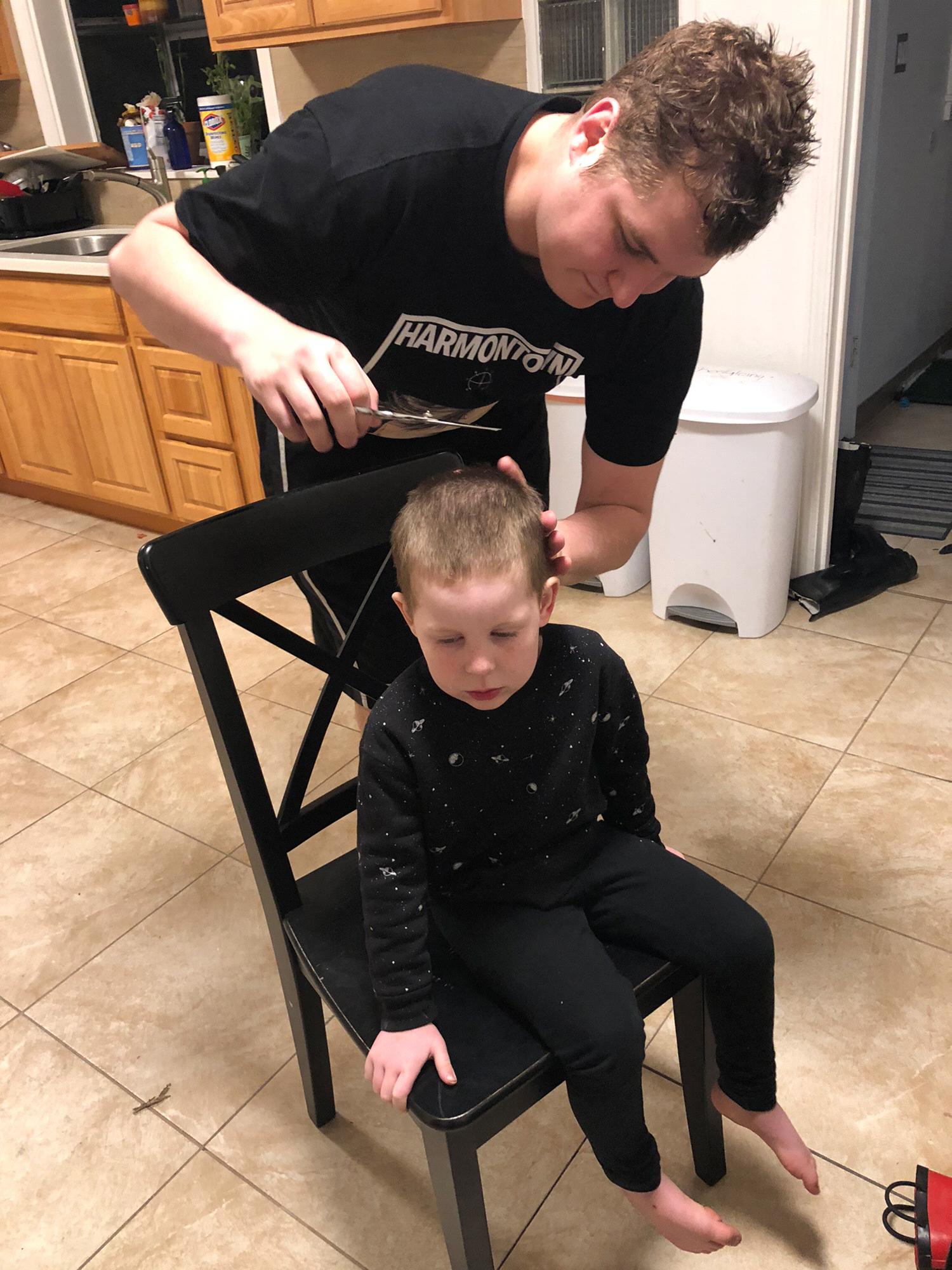 Conner cutting the ring-bearer's hair in our kitchen