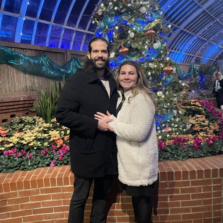 2025 Holiday Lights Show at Phipps Conservatory. Abby and Danny took a photo right where the proposal took place 7 months prior!