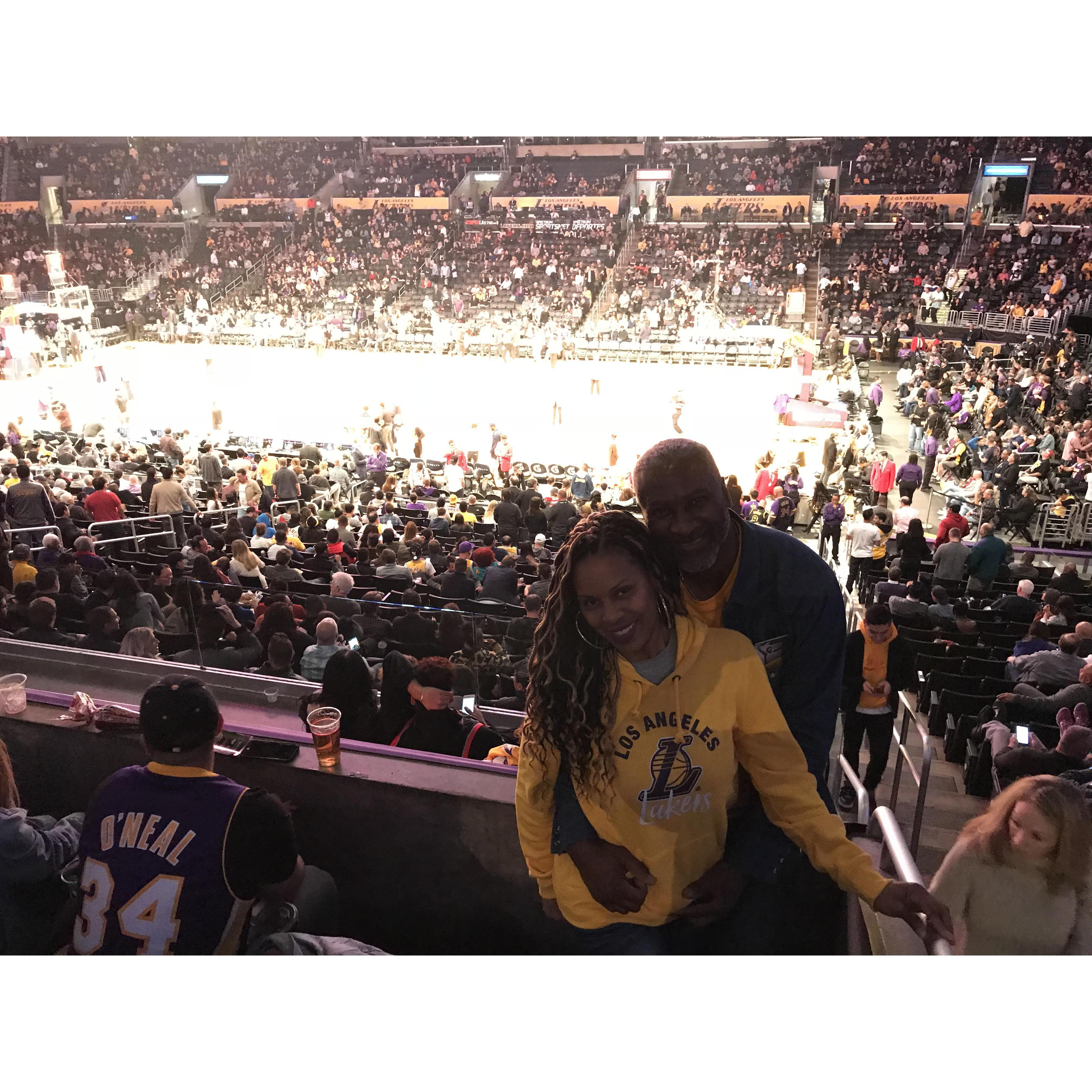 Having a great time with friends at Laker game.