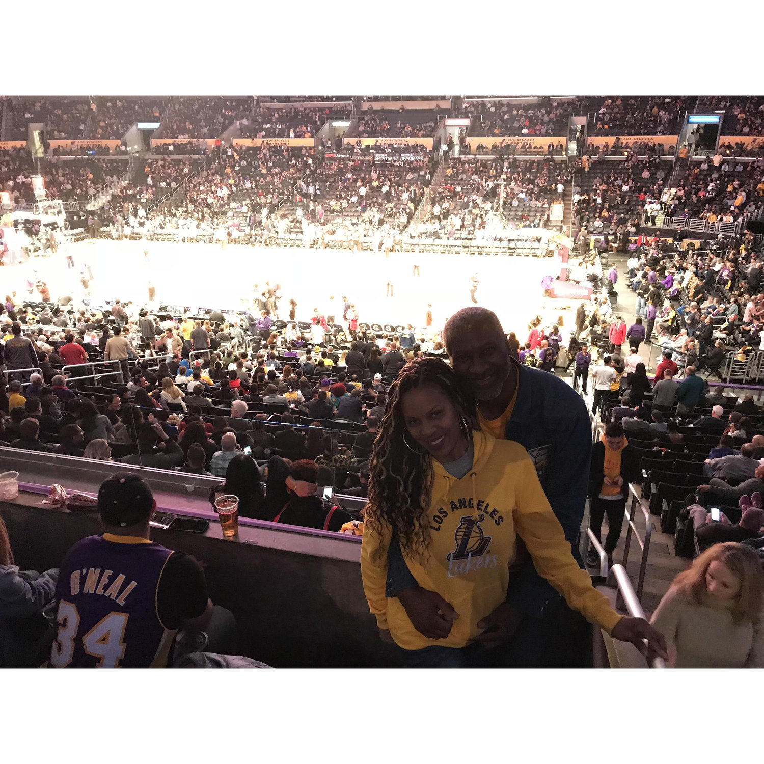 Having a great time with friends at Laker game.