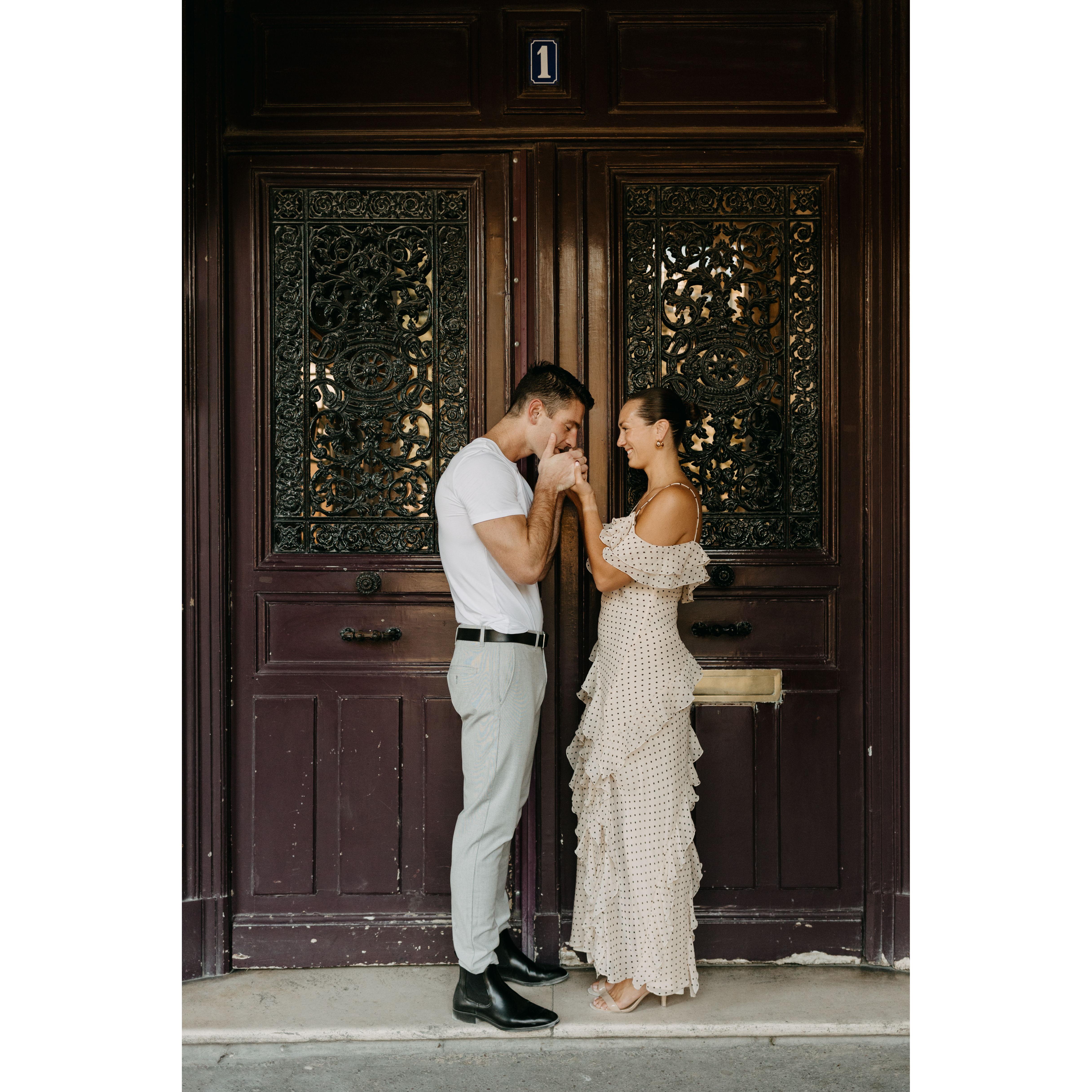 A Picture from their engagement shoot in front of the oldest doors in Paris.