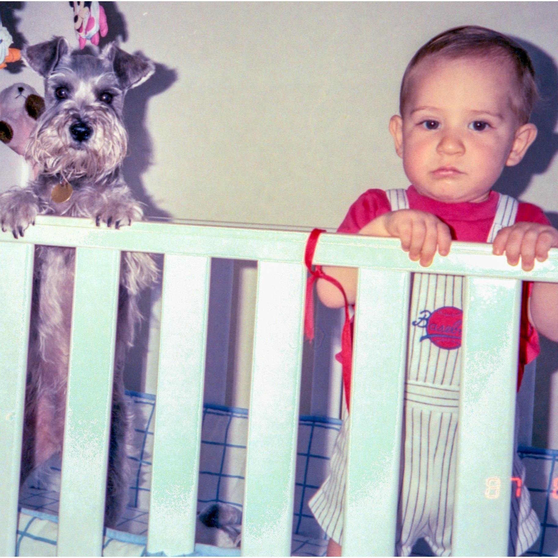 1987- Baby Kent and Tina, the family's miniature schnauzer.