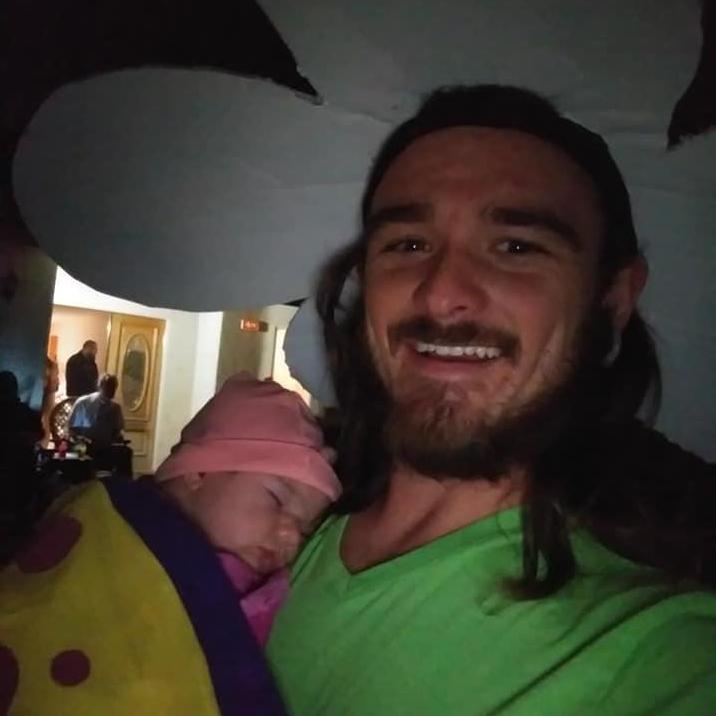 Tyler rocking his flower power while loving on his baby butterfly. Lyra's first Halloween, 2018.