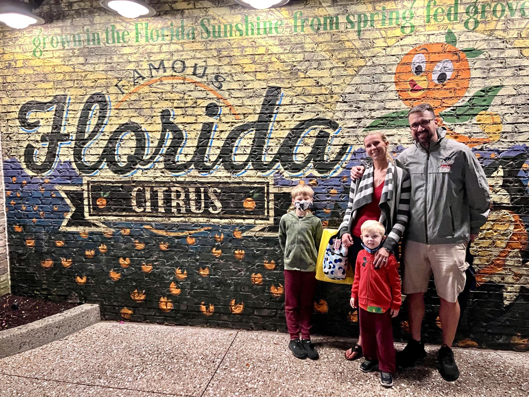 The tradition of a picture at the Florida mural at Disney Springs continues