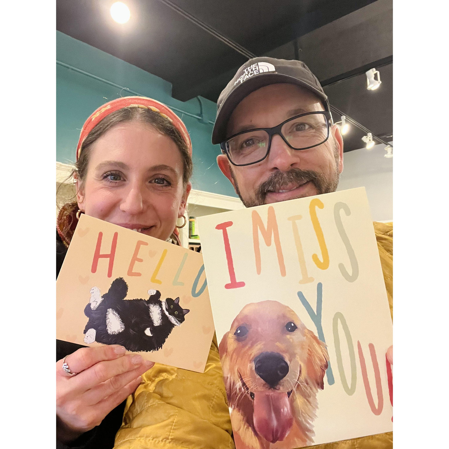 Us in a shop in Asheville that sells Lauren’s cards - these two feature her cat Sif, and Rob’s pup Nugget :)