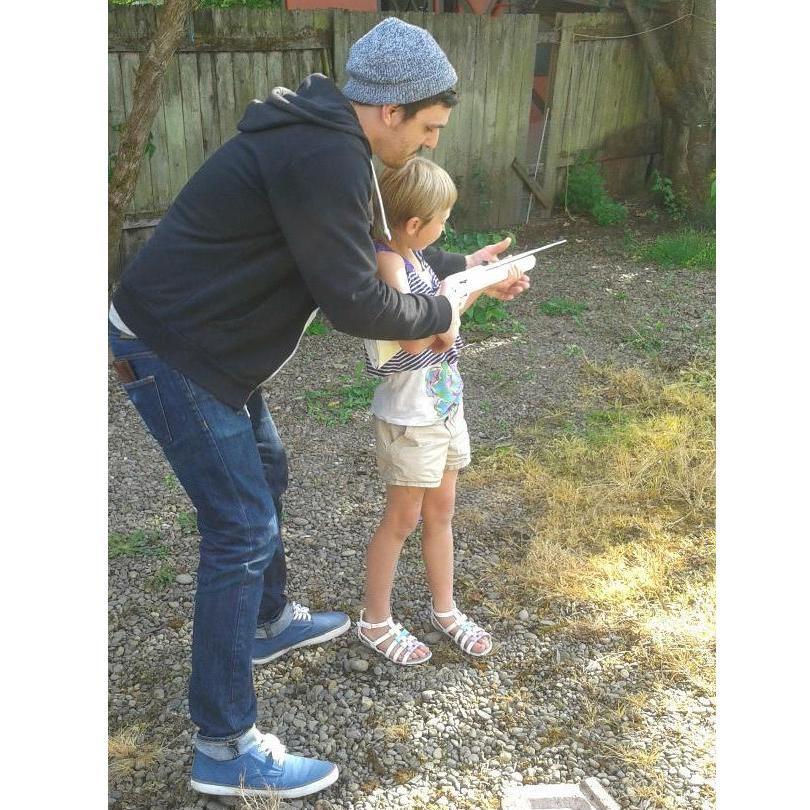 Austin teaching Debra's granddaughter Madison how to shoot a BB gun safely