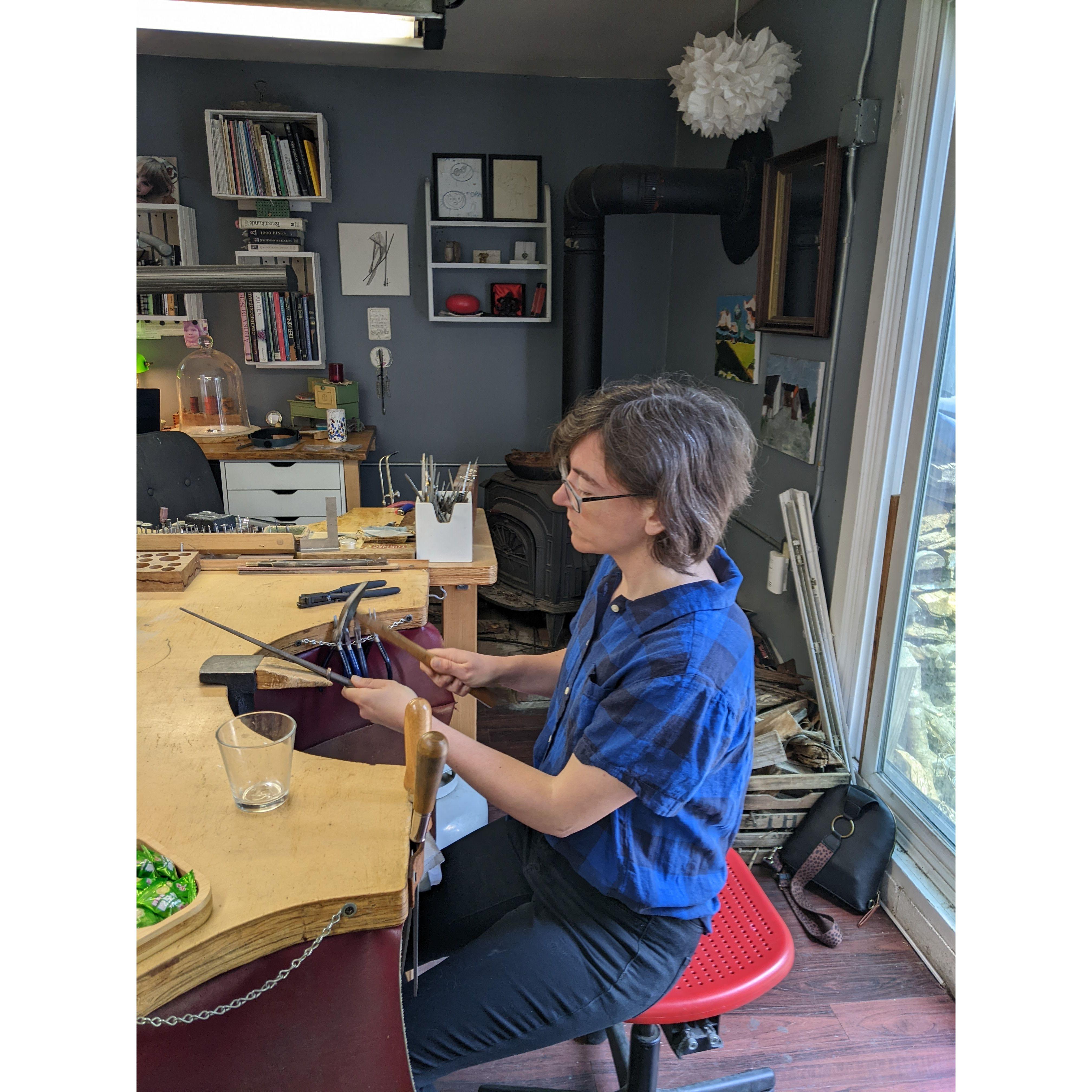 Once the rings were soldered, the metal is worked with a hammer over a metal rod to get into the right shape and size.