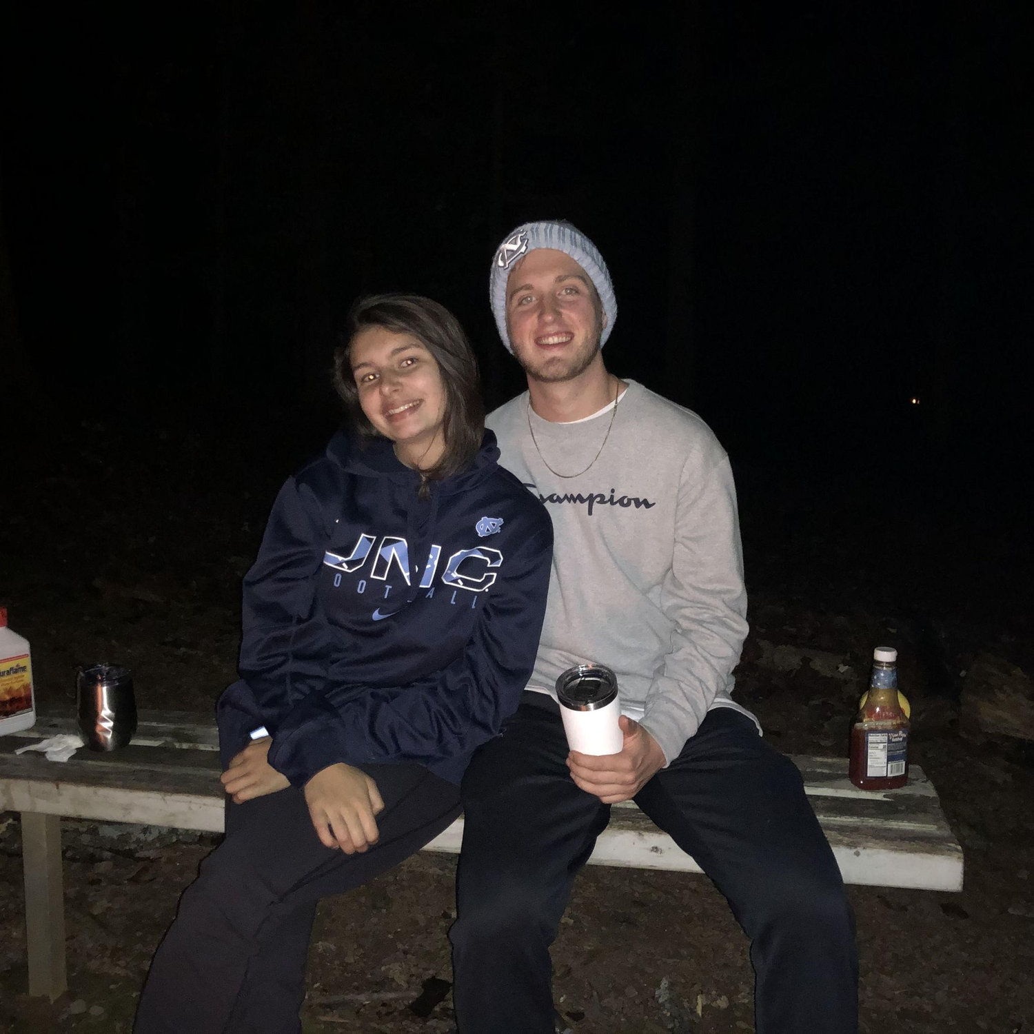 Cozying up by the fire while camping