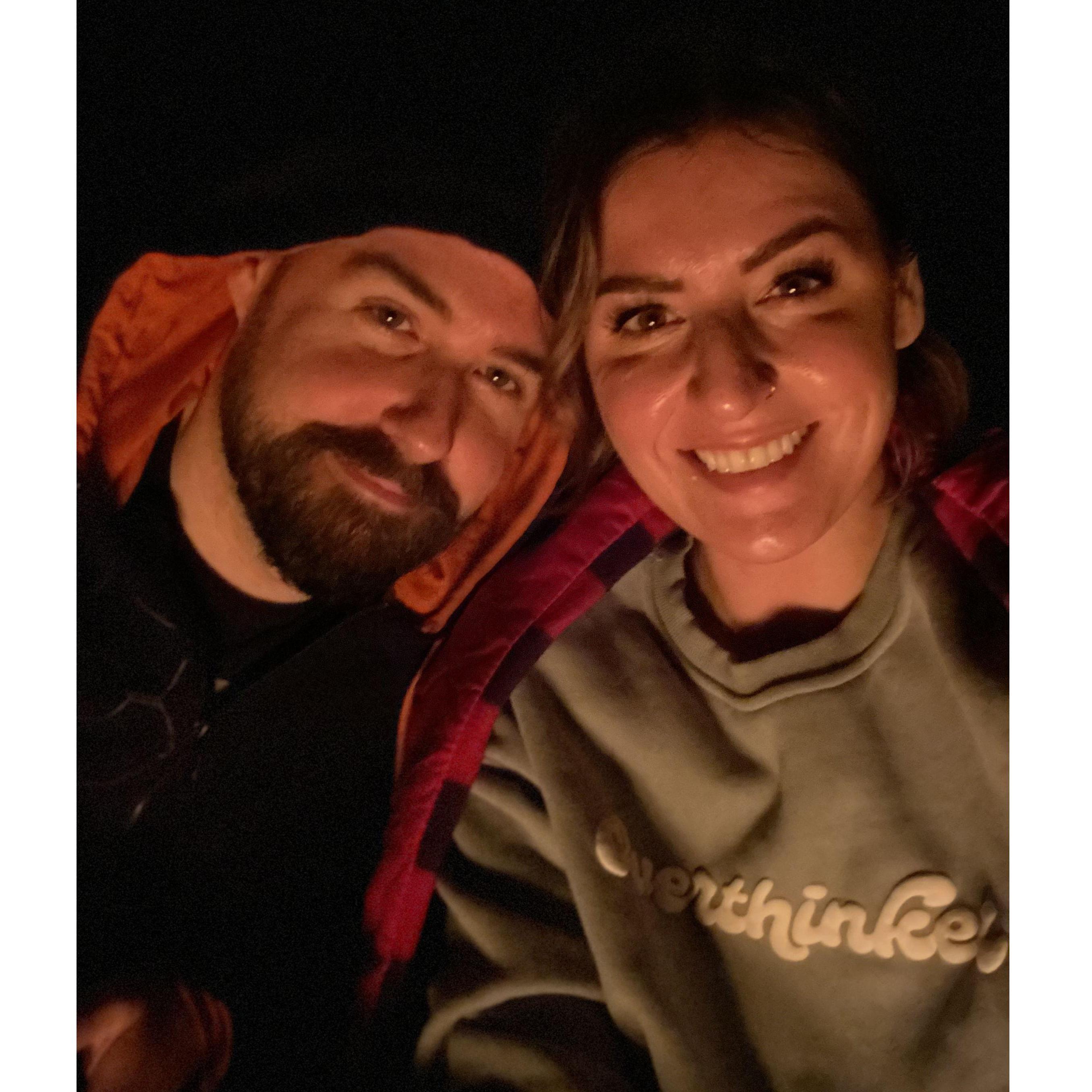 A rare photo of us (well, rare for Shelby) outdoors. Sitting around a campfire in Wisconsin, in September 2023.