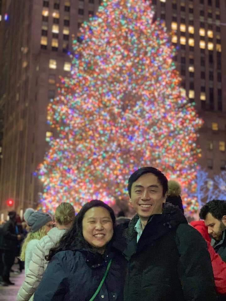 Us in front of a Christmas tree.