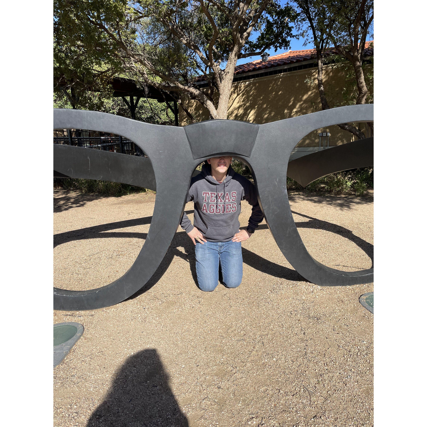 Cameron wearing Buddy Holly's giant glasses, Lubbock, TX, October 2023