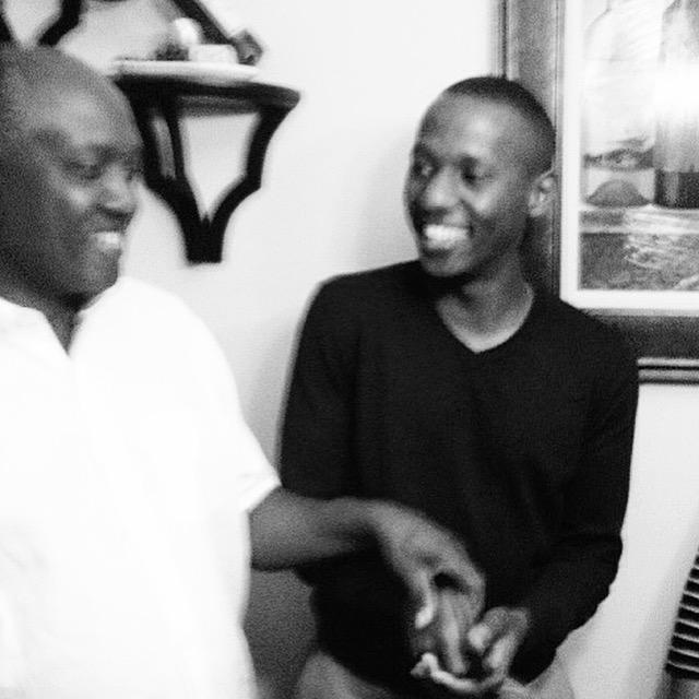 Ernest and Dad awkwardly trying to cut the plastic part of the cake