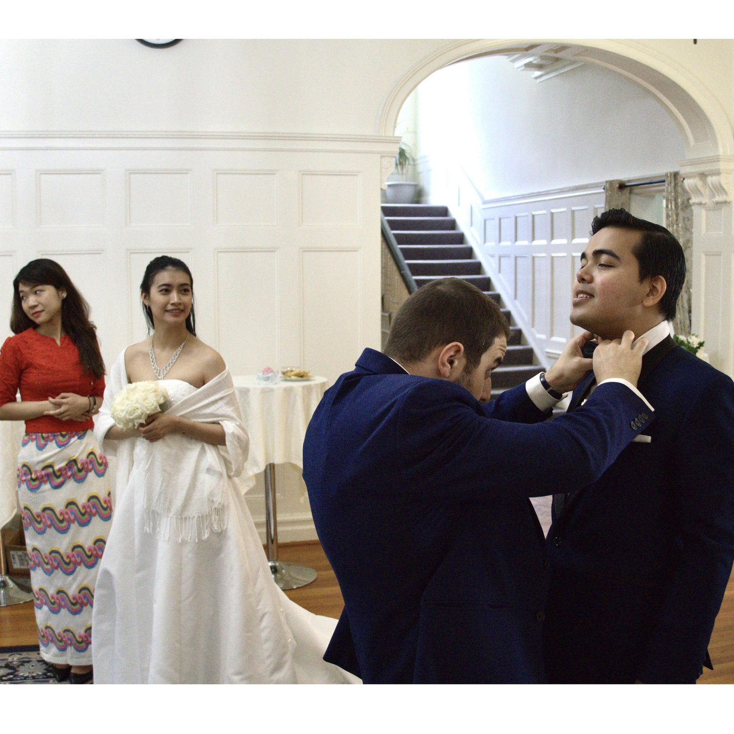 Best-man, Joseph Jorjoliani, fixing the groom's bowtie.